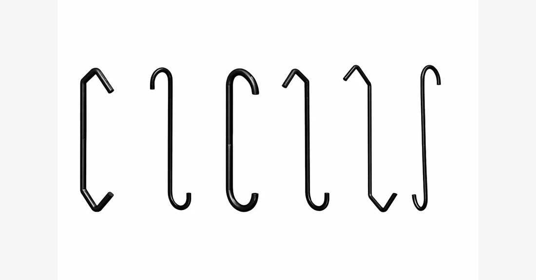 Assorted black powder coating hooks including S-hooks, V-hooks, C-hooks, and 90 degree hooks used in industrial powder coating lines.