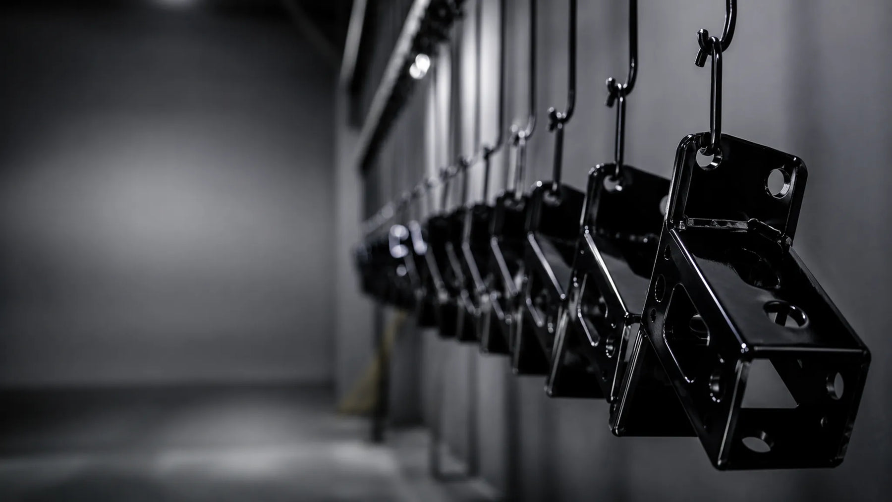 Powder coating hooks hanging on a clean industrial production rack